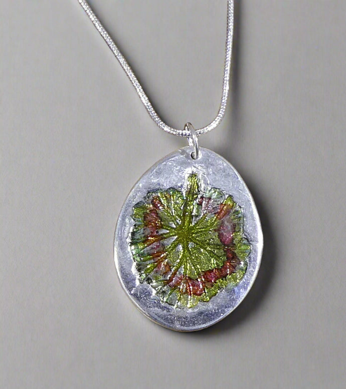 Jane Vernon Fine silver oval pendant with geranium leaf impression and colour