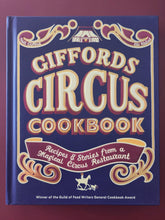 Load image into Gallery viewer, Giffords Circus Cookbook with decorative text and circus-themed design on a purple background