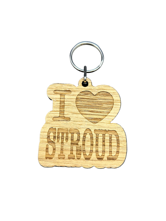 Wooden keychain with 'I love Strom' engraving on a dark background