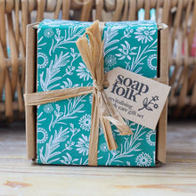 Load image into Gallery viewer, Gift set with floral design packaging and 'Soap Folk' label on a wooden surface